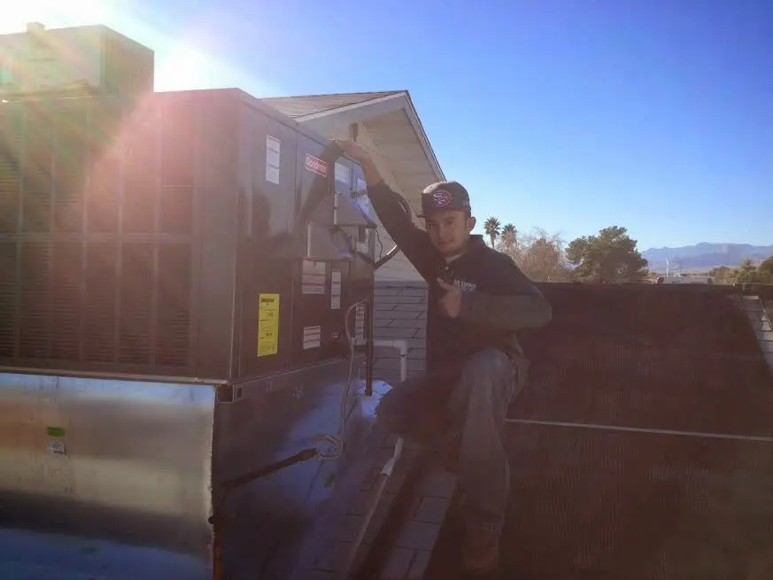 HVAC technician performing Boiler Repair on a rooftop unit in Green Bay